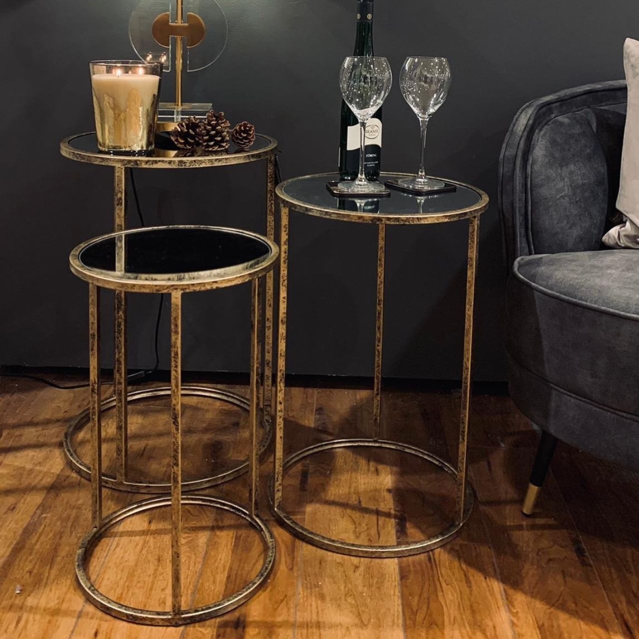Mindy Brownes Mirror Top Nest of Tables Set of 3  Three Pod Tables that neatly stack on top of one another. Champagne gold colour in finish and a mirror top. A beautiful addition to any home. These tables only stack on top of one another, or side by side, underneath bars should not be crossed. 