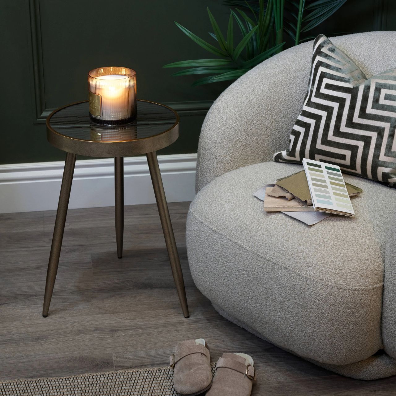 This beautiful tripod table features a mirrored top with a flowing wave design and a sleek distressed finish. Its elegant three legged base creates a light, balanced look while reflecting light to enhance the space.