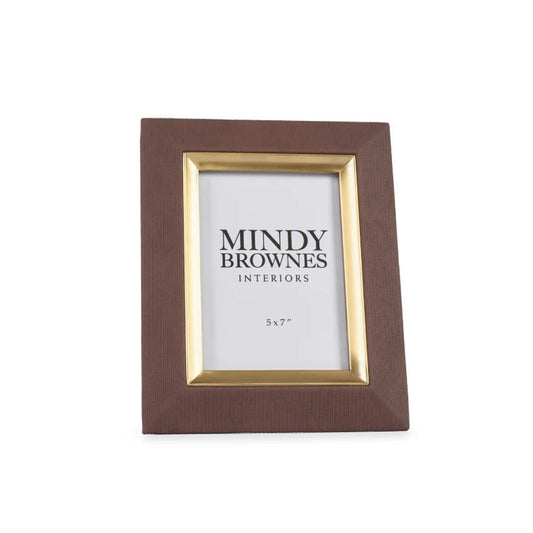 The Sutera Picture Frame in Brown 5x7 boasts a classic and elegant design with gold accents. The perfect way to preserve and showcase your memories, this photo frame adds a touch of sophistication to any room. Timeless and versatile, it complements a variety of décor styles.