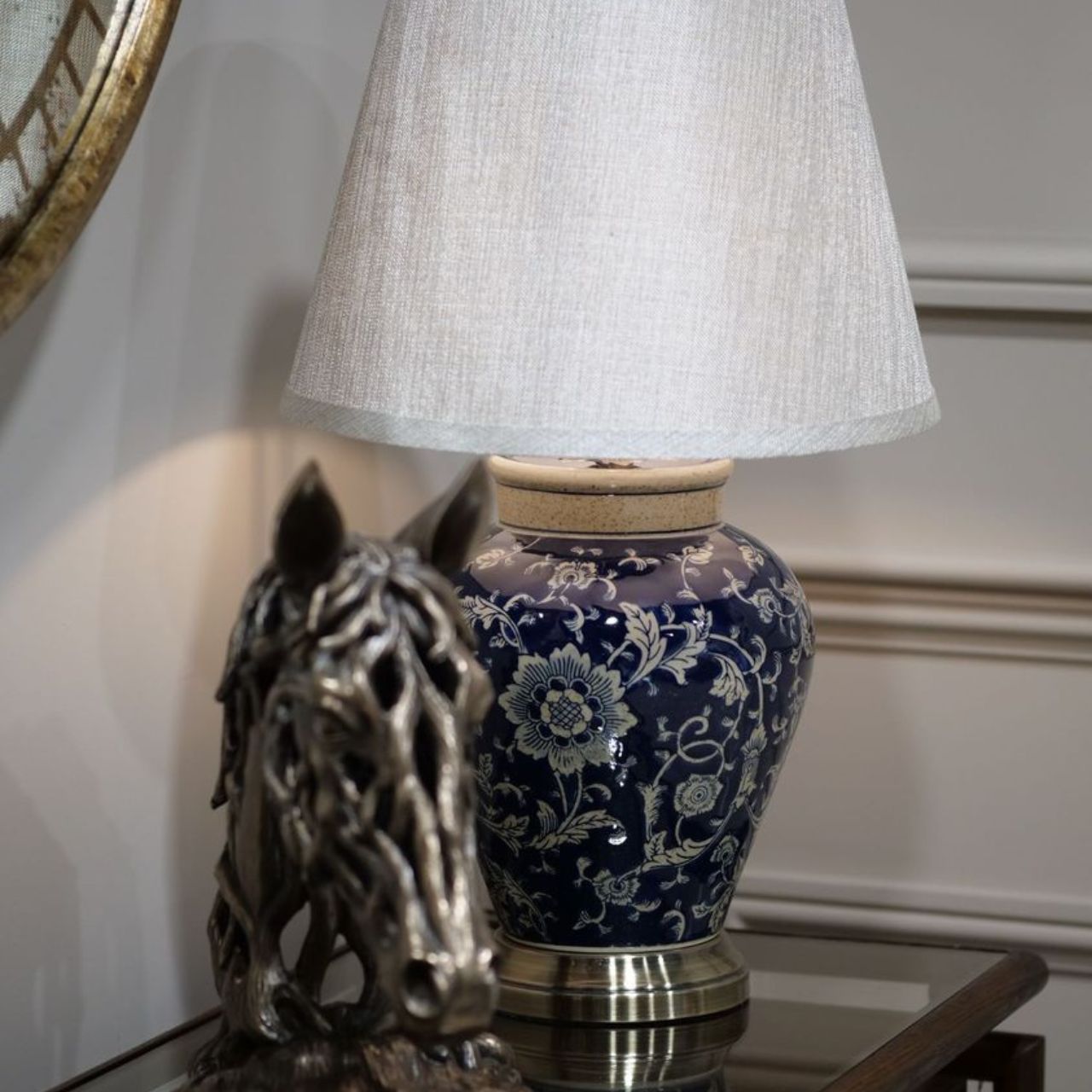 Tessa Lamp by Mindy Brownes  Blue ceramic floral pattern lamp. Brass antique bass and top. Off white linen shade.