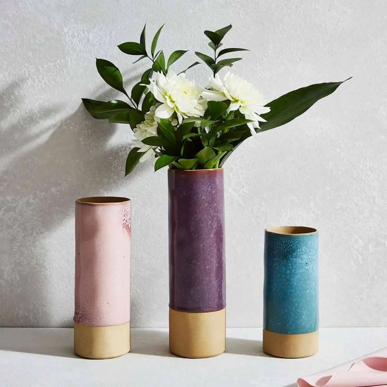A beautiful vase featuring a captivating teal glaze