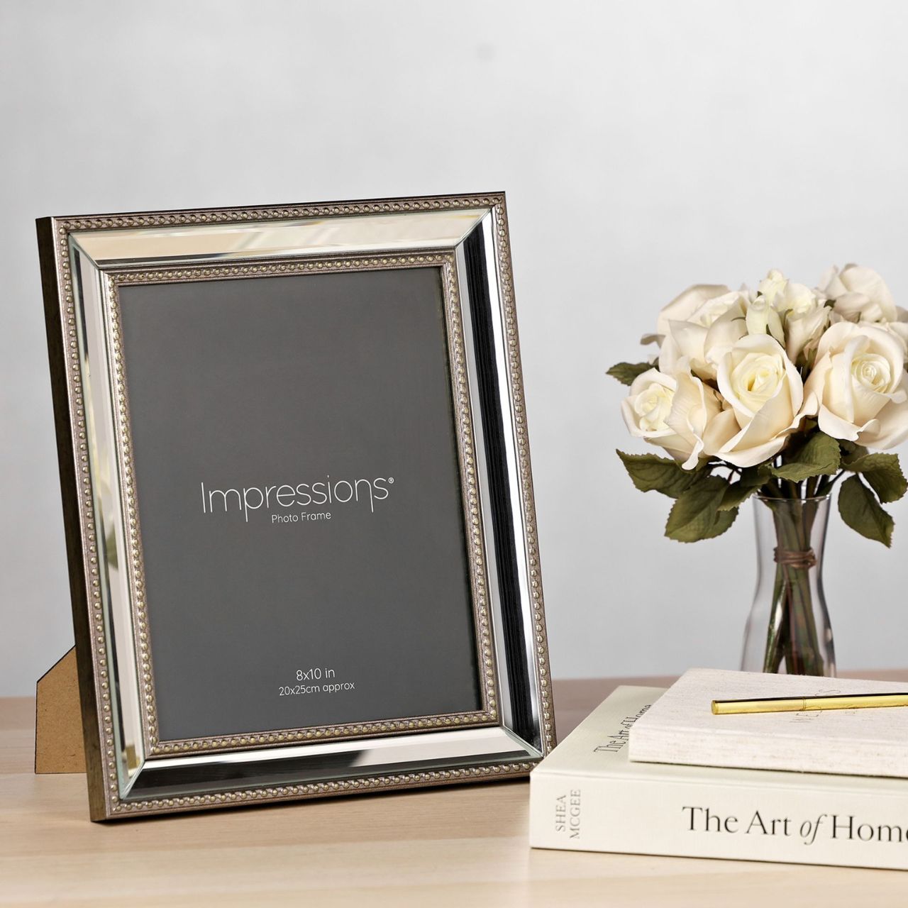 This elegant frame features a gold border with an intricate beaded pattern, adding luxury to your memories. The bold black background provides contrast, making "Impressions" stand out.