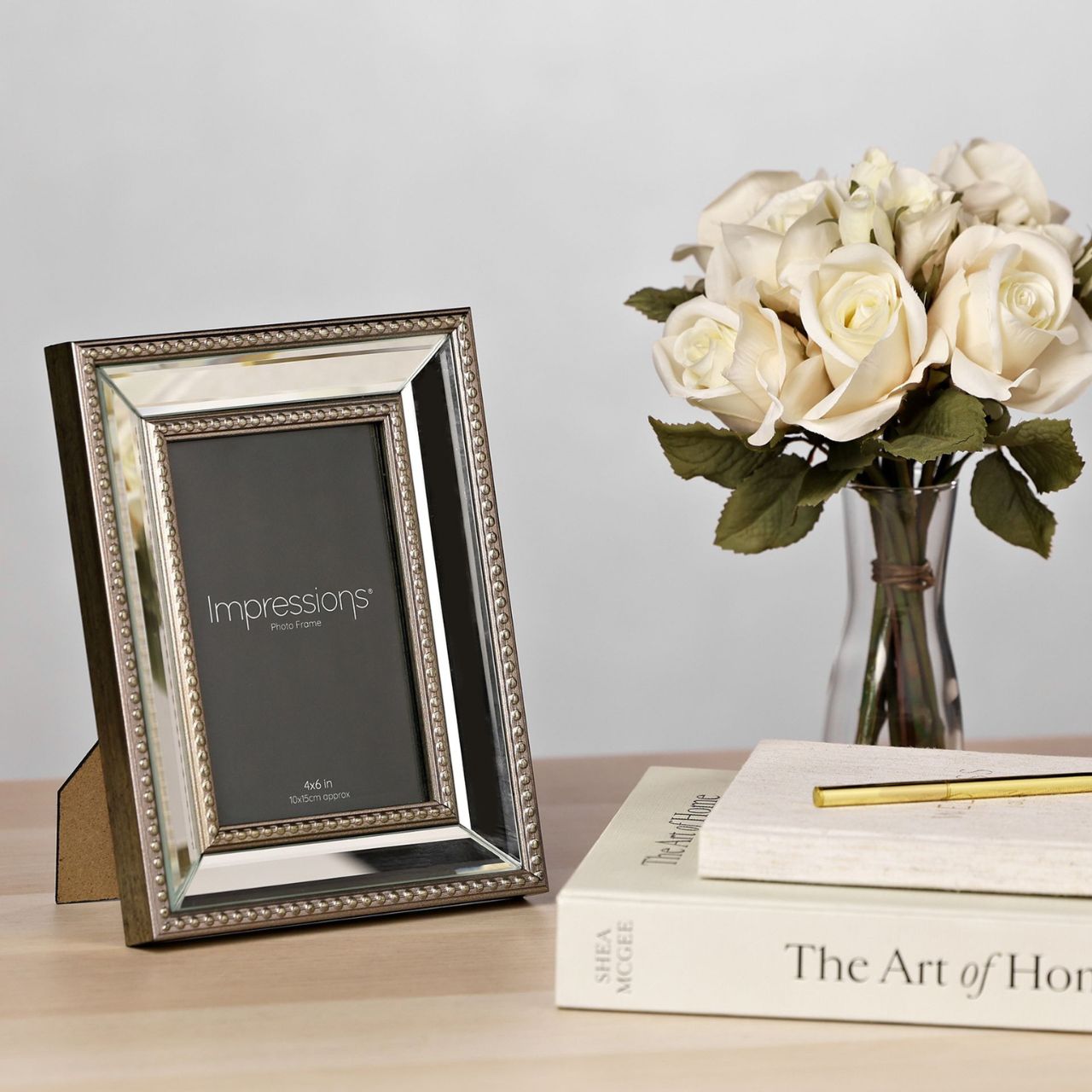 The Impressions Mirror Photo Frame Gold Decorative Border 4" x 6" beautifully displays cherished memories. With an elegant gold border and mirrored background, this frame adds glamour to any photo.