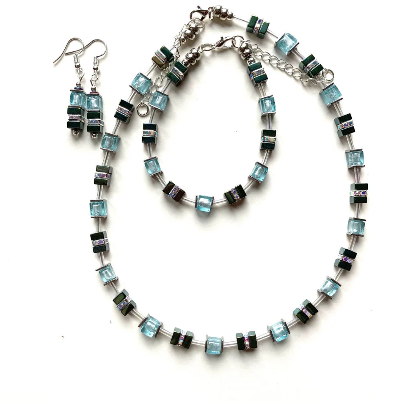 These earrings comes with silver-lined Murano-style glass cubes in aqua, complemented by Hematite gemstone squares in sea green with the added sparkle of silver Rhinestone spacer beads.