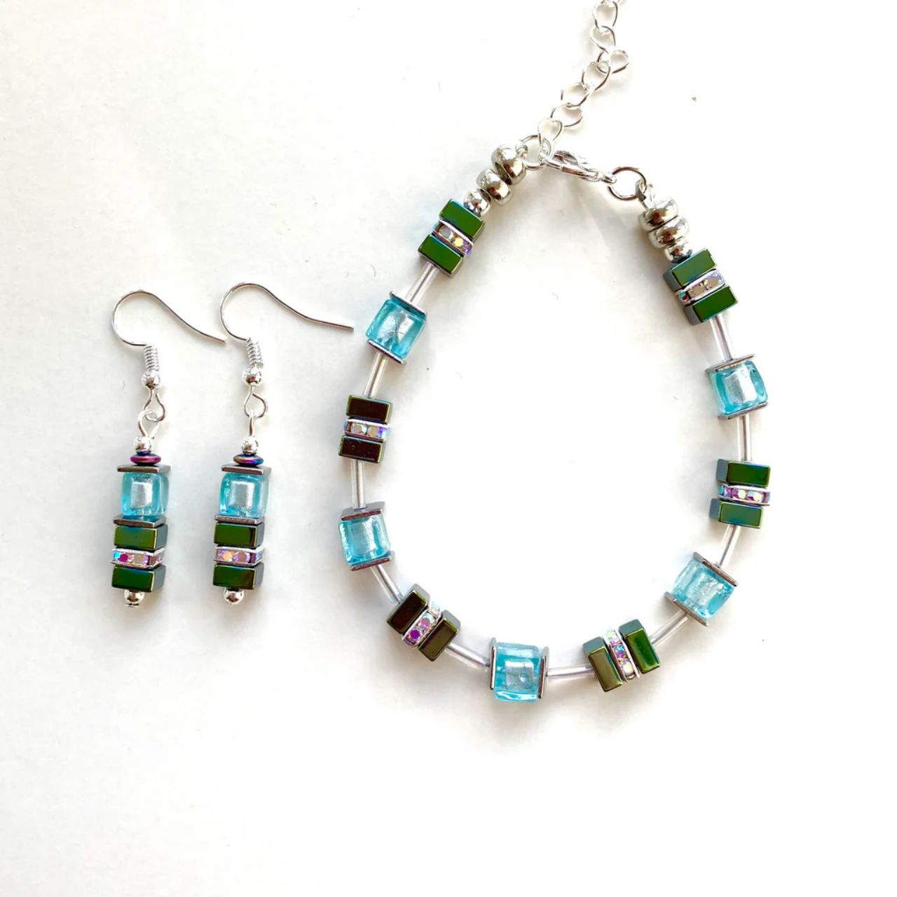 These earrings comes with silver-lined Murano-style glass cubes in aqua, complemented by Hematite gemstone squares in sea green with the added sparkle of silver Rhinestone spacer beads.