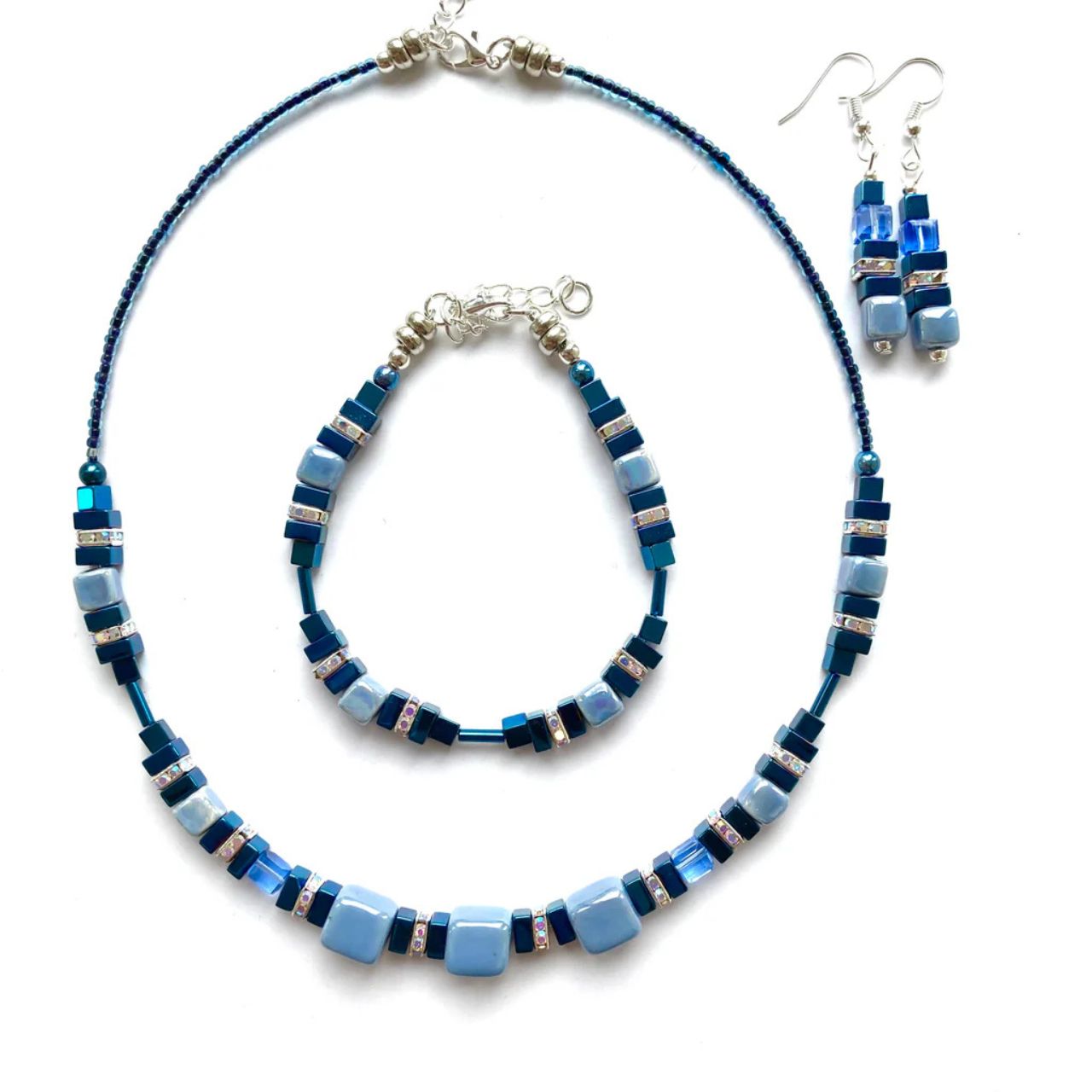 These earrings combine cubes of blue handmade Ceramic cubes in shades of blue with blue Hematite gemstone squares and cubes, blue faceted Crystal cubes and sparkling rhinestones.