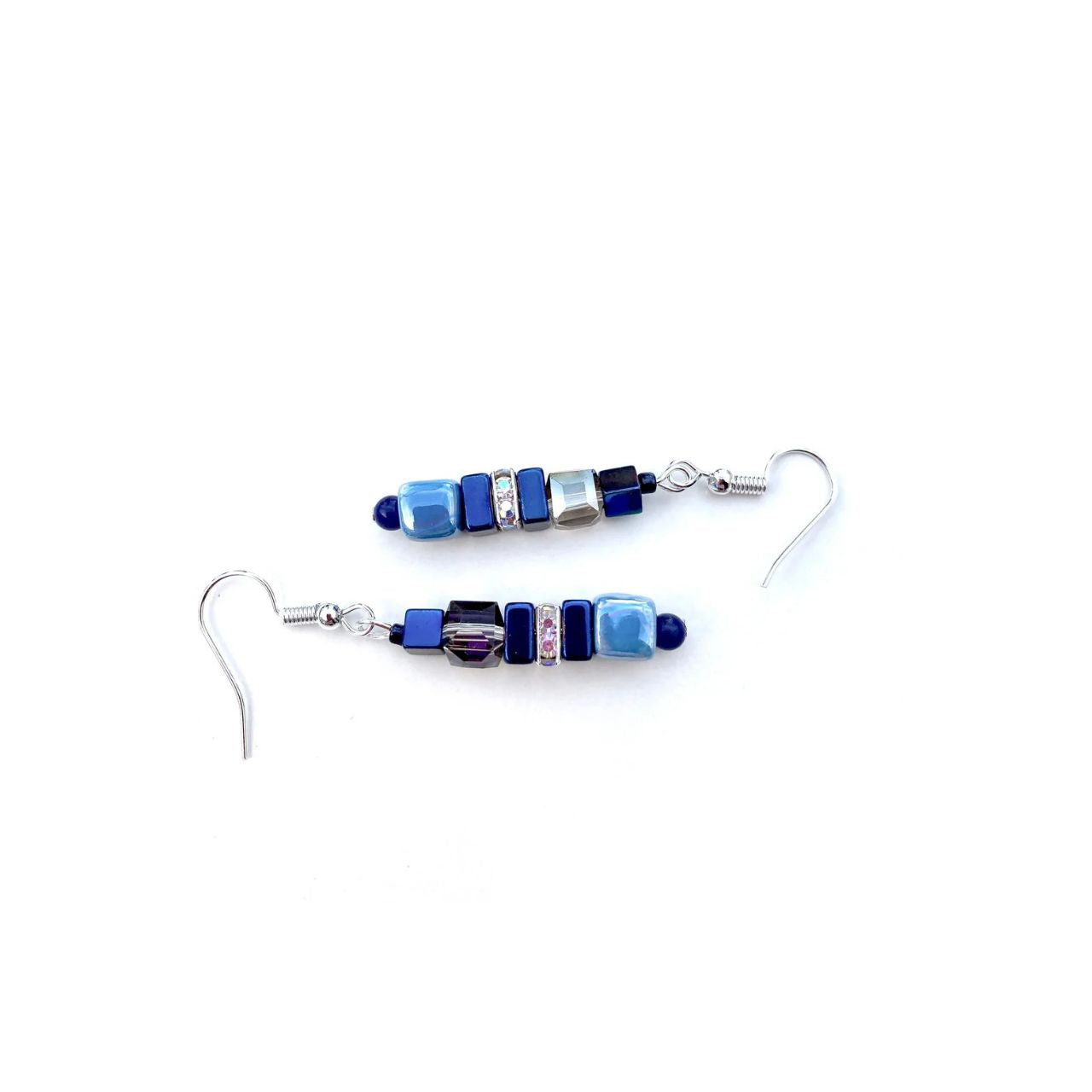 These earrings combine cubes of blue handmade Ceramic cubes in shades of blue with blue Hematite gemstone squares and cubes, blue faceted Crystal cubes and sparkling rhinestones.