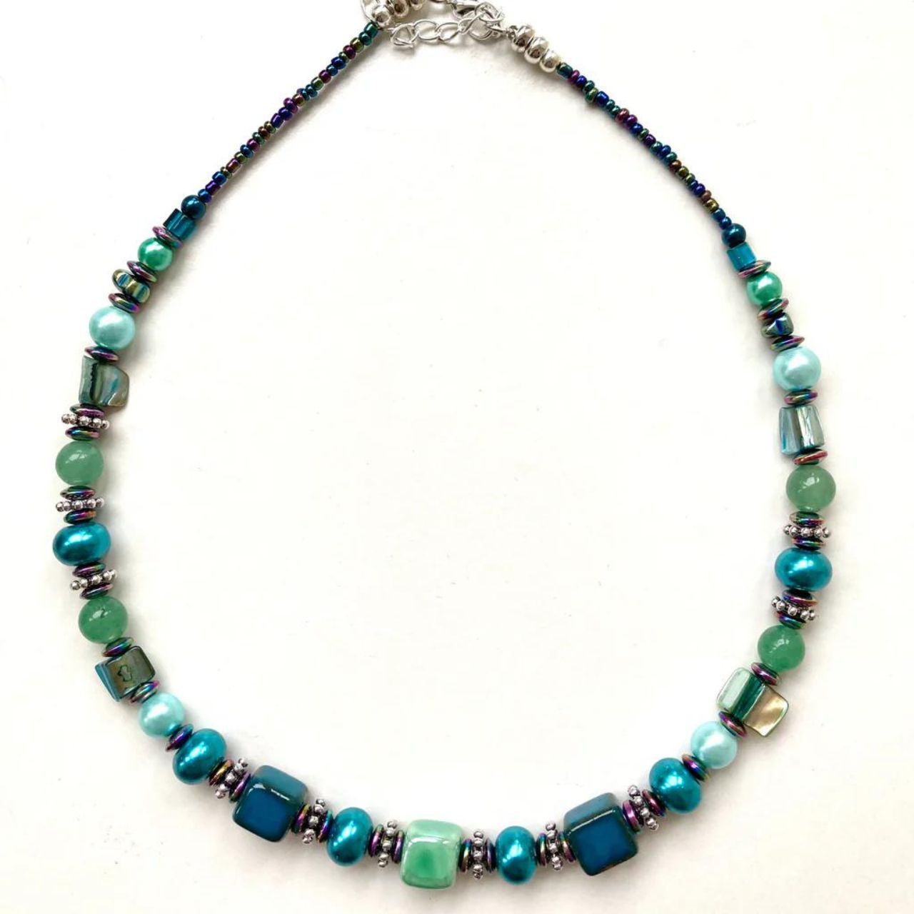 Necklace with blue/green Ceramic cubes, Amazonite and Hematite gemstones and blue/green natural shell beads. Length: approximately 16 inches (40cms) with a 2 inch (5 cm) extension chain.