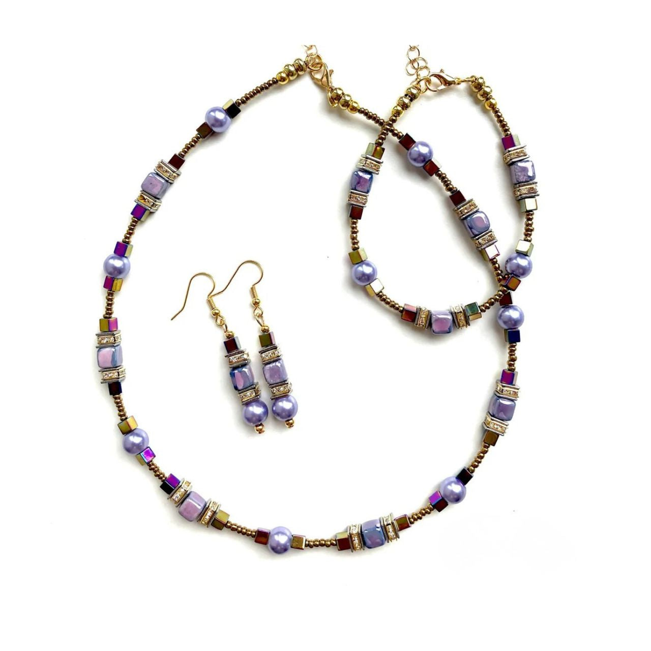 Combined cubes and spheres for a dynamic effect using lilac coloured Ceramic cubes and gold plated Hematite gemstones teamed with toning Pearls, all interspersed with sparkling Rhinestone spacer beads, creating an easy to wear and flattering piece of jewellery.