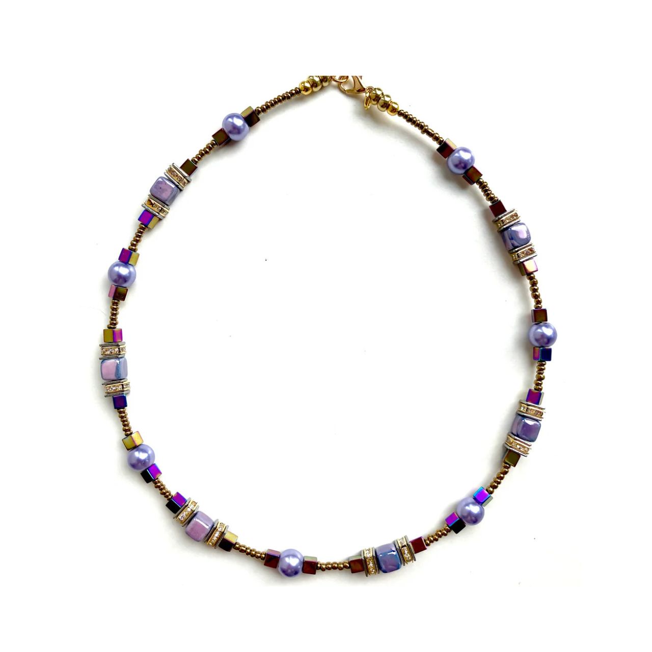 Combined cubes and spheres for a dynamic effect using lilac coloured Ceramic cubes and gold plated Hematite gemstones teamed with toning Pearls, all interspersed with sparkling Rhinestone spacer beads, creating an easy to wear and flattering piece of jewellery.