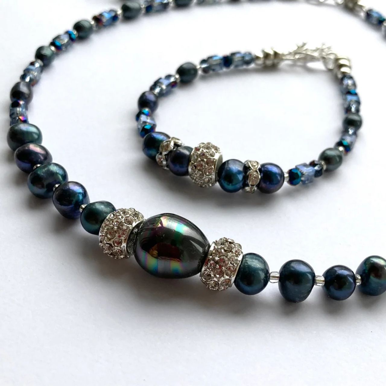 These freshwater Pearls have an unsurpassed natural beauty. Their deep blue colour is complemented by little faceted blue Crystal rondelles and cubes and highlighted by elegant cubic zirconia-studded silver collars.