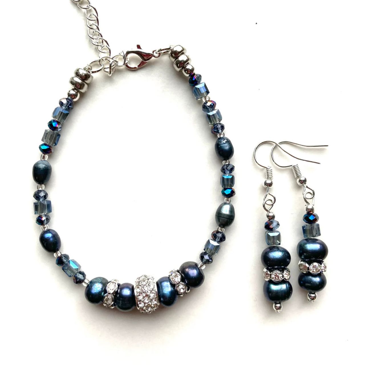 These freshwater Pearls have an unsurpassed natural beauty. Their deep blue colour is complemented by little faceted blue Crystal rondelles and cubes and highlighted by elegant cubic zirconia-studded silver collars.