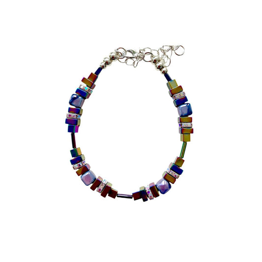 Lilac and white handmade Ceramic Cubes are combined with rainbow hued Hematite gemstone squares and sparkling silver-plated Rhinestone spacers.