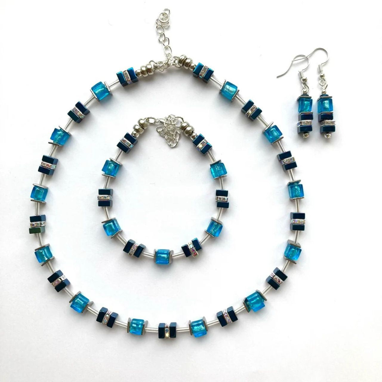 These earrings comes with silver-lined Murano-style glass cubes in ocean blue complemented by Hematite gemstone squares in marine blue with the added sparkle of silver Rhinestone spacer beads.