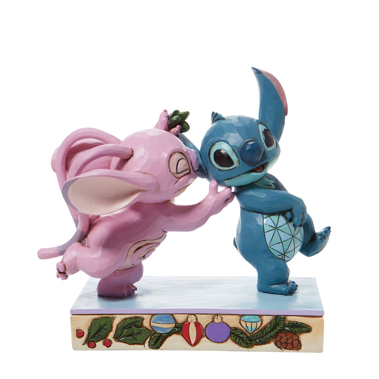 Disney Stitch and Angel with Mistletoe Figurine - Mistletoe Kiss  Stitch the holiday hooligan meets his match under the mistletoe this season. The pair of mischievous aliens share a smooch in this sweet Jim Shore figurine. Colourfully lined in ornaments, the pair make a lovely addition to any home - even on Earth.