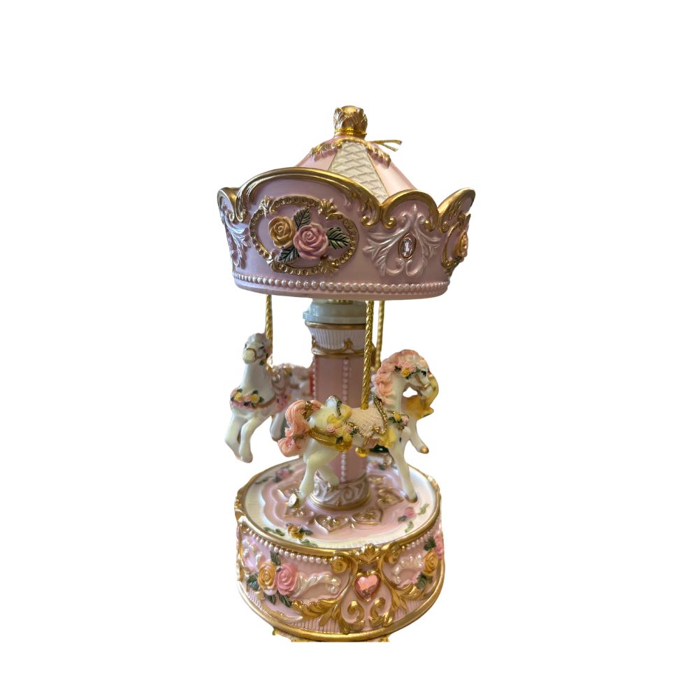 Rose and white carousel with 3 horses and decorated with yellow and rose roses and colourful rhinestones turns to the melody A little night music.