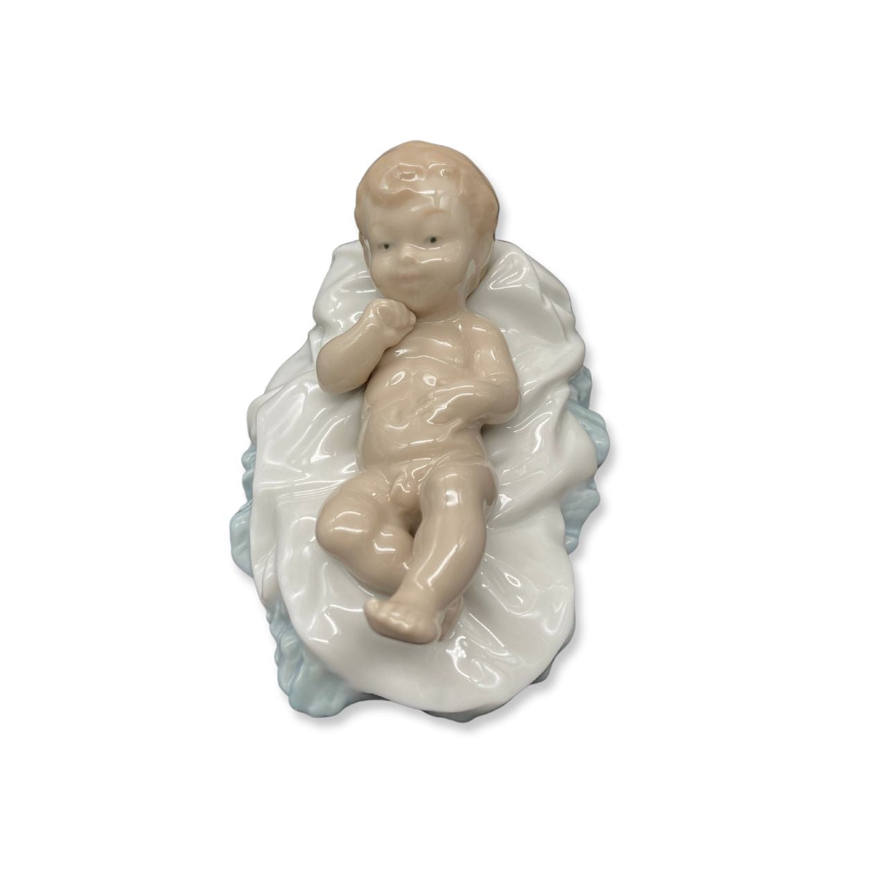 Nao by Lladro Baby Jesus  Nao porcelain figurine “Baby Jesus” from the Christmas Collection.  Sculpted by Salvador Furió, this figurine is part of the nativity set.  Nao Porcelain Figurines are produced in Valencia Spain and the Company is part of the Lladro family. Each piece is lovingly handmade and hand painted by the Valencia Artisans.