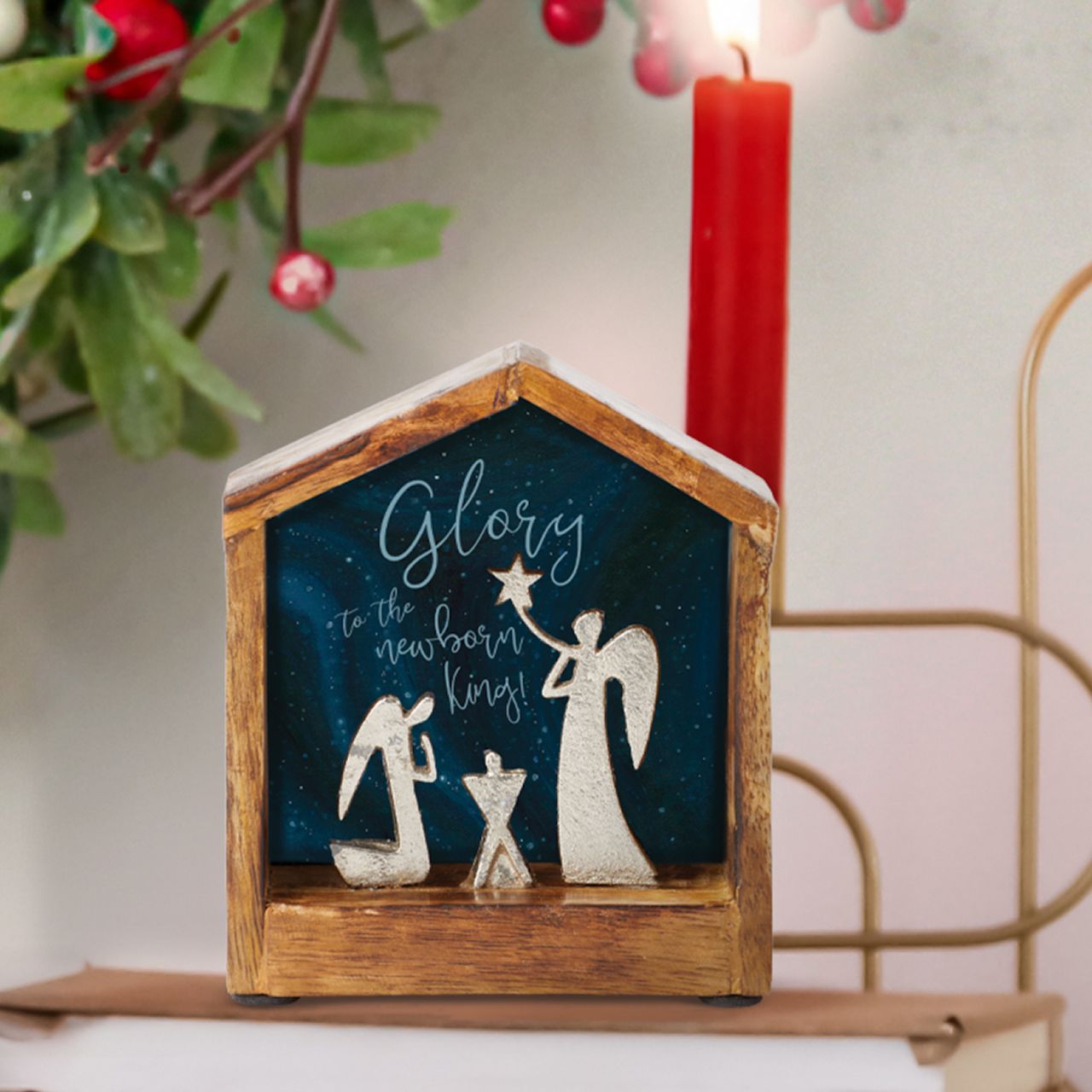 Artist, Wendy Wiinanen, crafts memorable and miniature traditional Christmas moments from mango wood and aluminium. This enchanting display places two angels in a wooden stable peering over a cradle.