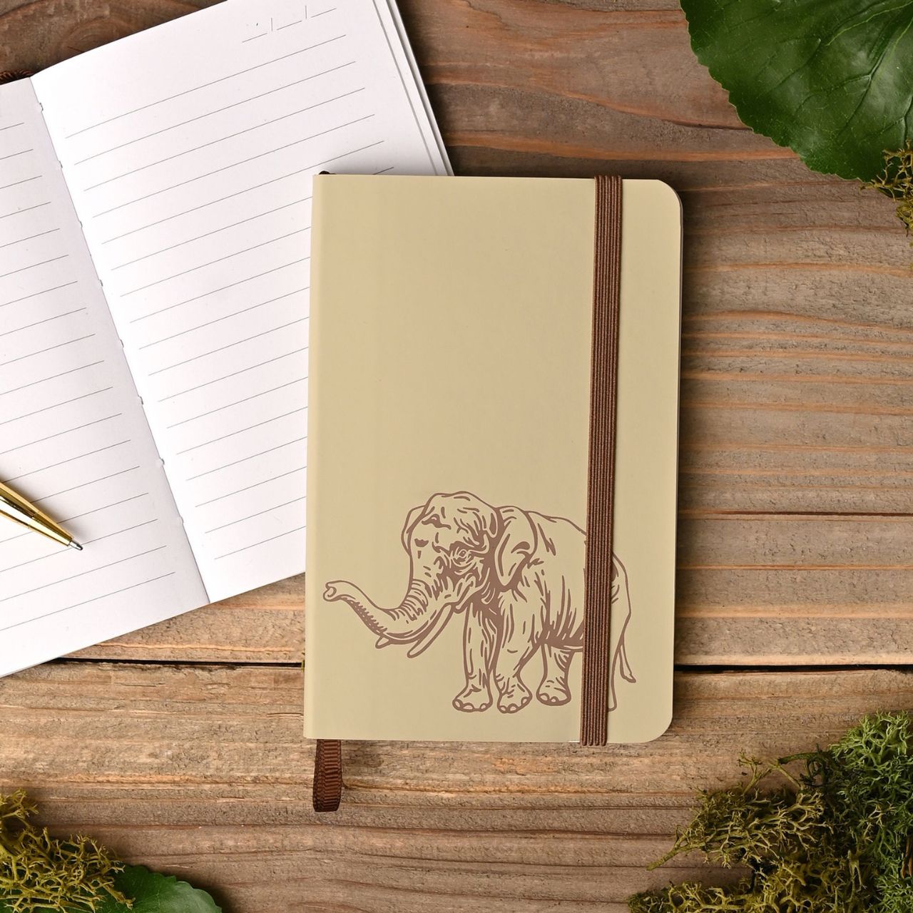 Notebook with elephant design on a wooden surface