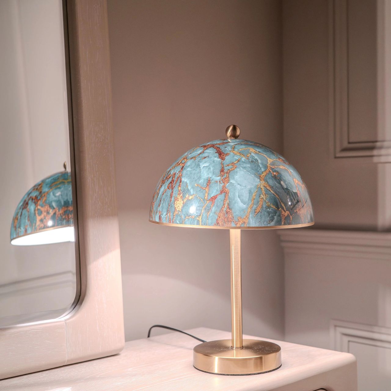 Introducing the&nbsp;Neesha Lamp, a must-have for any modern workspace. With its sleek and eye-catching green and gold design, this striking desk lamp is the perfect blend of style and functionality. Its unique design will add a touch of personality to your work environment, while providing ample light for any task.