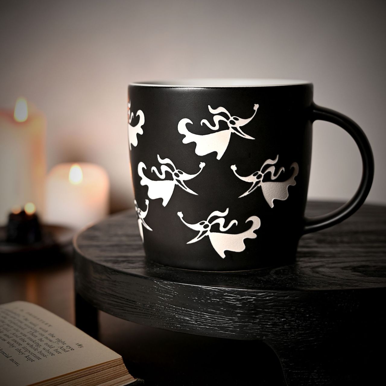 Bring spooky charm to your morning brew with this Disney Nightmare Before Christmas Zero mug. Featuring the lovable ghost dog from Tim Burton's classic film, this black ceramic mug is adorned with a hauntingly beautiful pattern of white floral and leaf-like designs.