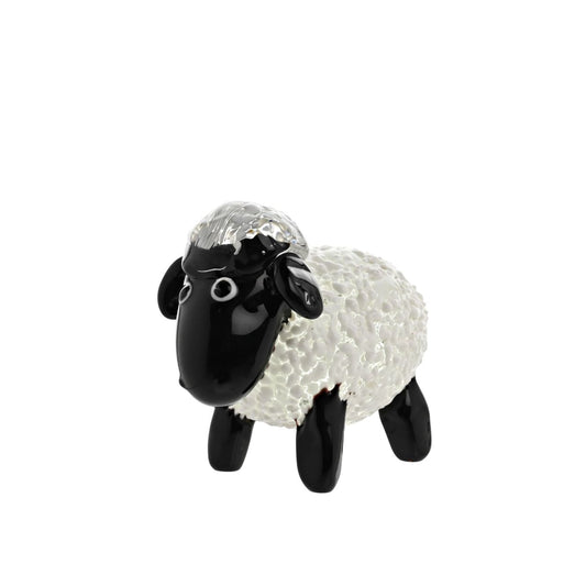 Savour the charm of this Objets d'art Glass Figurine - Sheep. This distinctive ceramic piece, brimming with character, showcases a fluffy textured body with contrastingly sleek black legs and face, making it an irresistible addition to your collection or an enchanting gift.