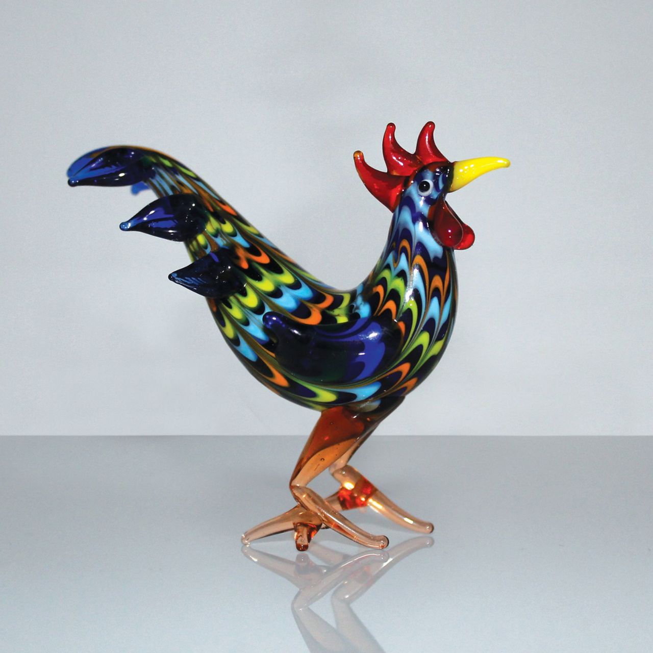 A beautiful stylised handmade coloured glass Cockerel ornament. From Objets d'Art by SOPHIA - hand blown and one hundred percent unique.