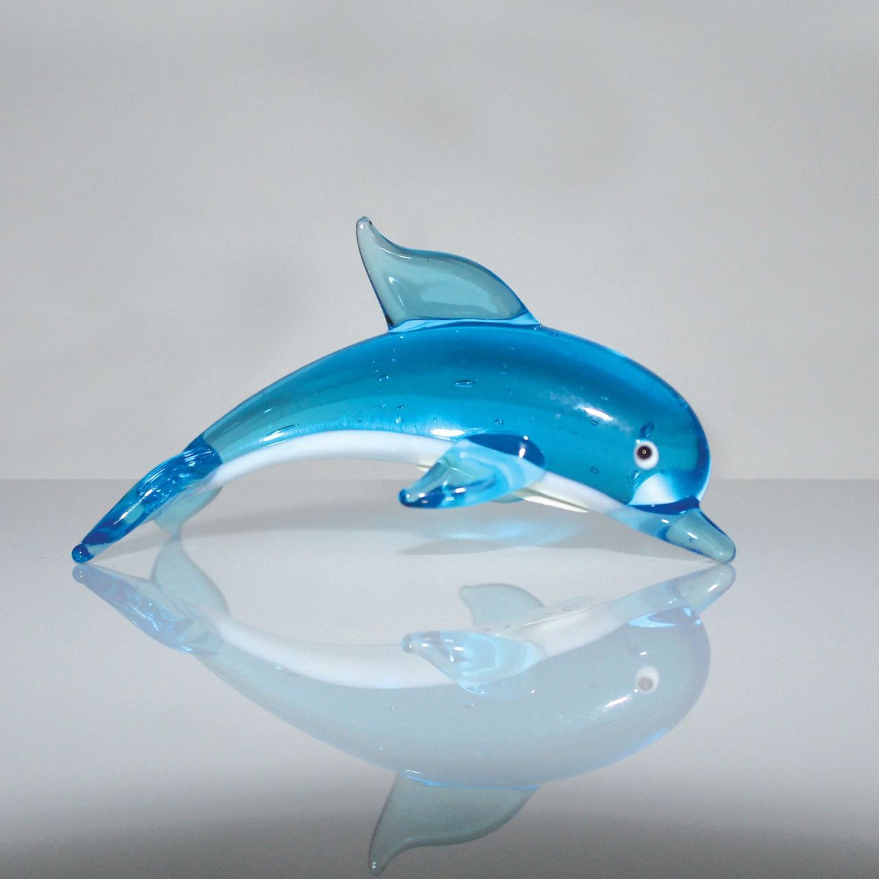 A beautiful stylised handmade coloured glass Dolphin ornament. From Objets d'Art by SOPHIA - hand blown and one hundred percent unique.
