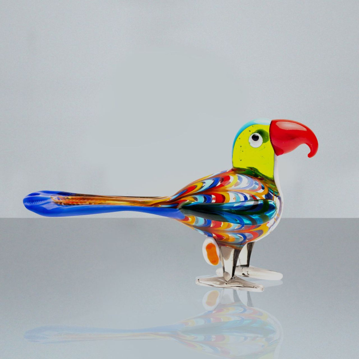 A beautiful stylised handmade coloured glass Parrot ornament. From Objets d'Art by SOPHIA - hand blown and one hundred percent unique.
