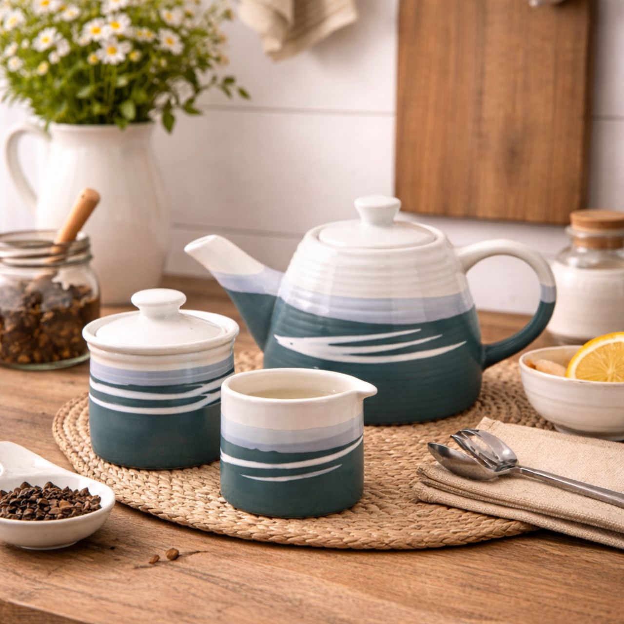 This Paul Maloney Pottery Teal Milker & Sugar Bowl is a perfect addition to any kitchen. Crafted from the highest quality materials, this set provides both convenience and style. The teal colour is sure to complement any table or countertop. Use it to store small items or to add decoration to your kitchen.