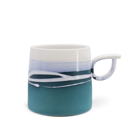 Tipperary Crystal Paul Maloney Pottery Teal Mug  This Paul Maloney Pottery Teal Mug is the perfect way to enjoy your favorite hot beverage. Crafted by renowned potter Paul Maloney, this mug is made of durable and long-lasting clay, with a glazed teal finish that is sure to impress. Ideal for all kinds of hot drinks, this mug is sure to bring elegance to your morning routine.