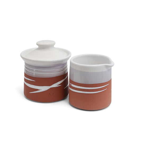 This Paul Maloney Pottery Terracotta Milker &amp; Sugar Bowl is a perfect addition to any kitchen. Crafted from the highest quality materials, this set provides both convenience and style. The Terracotta colour is sure to complement any table or countertop. Use it to store small items or to add decoration to your kitchen.