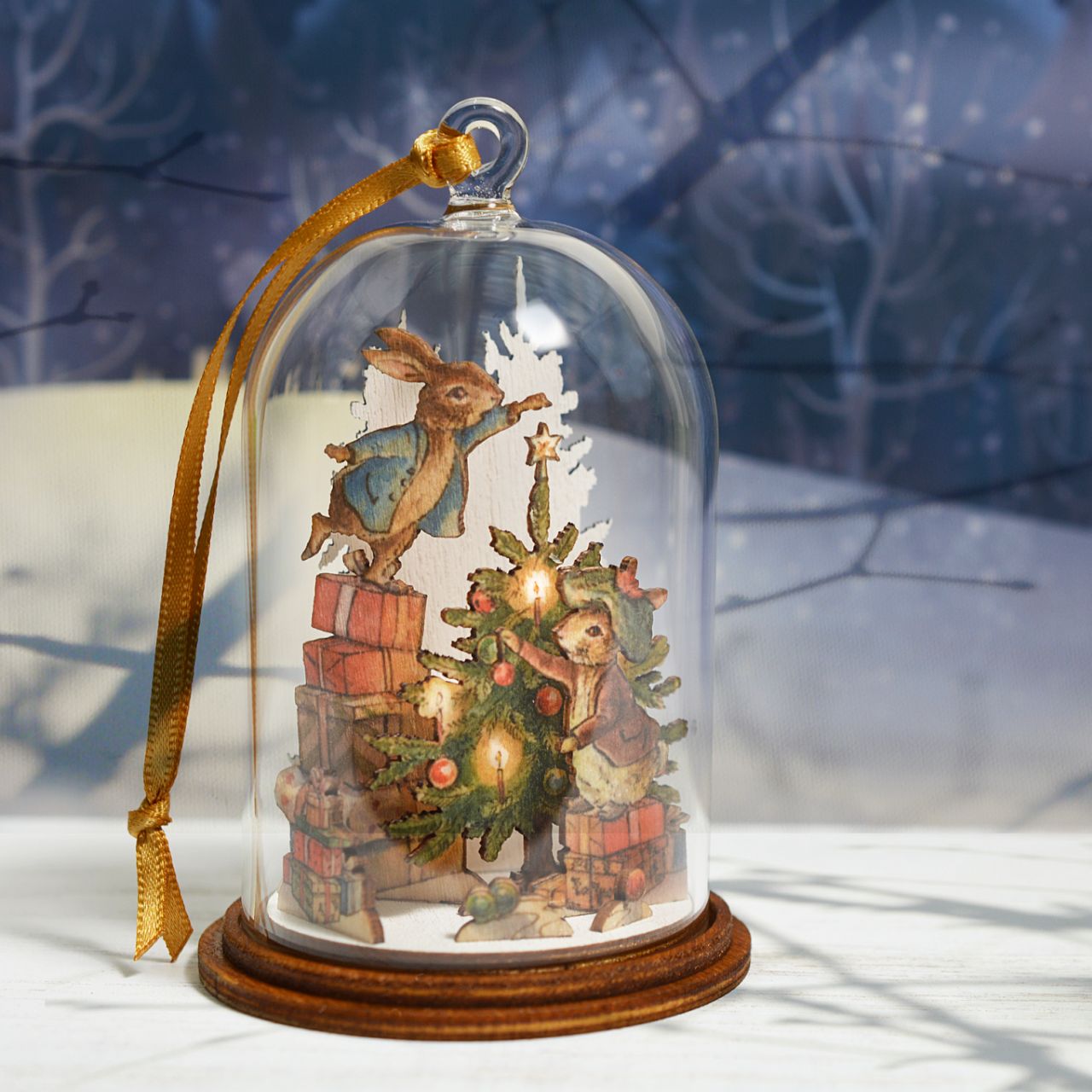 Peter Rabbit and Benjamin Bunny Christmas Wooden Hanging Ornament  This festive Peter Rabbit and Benjamin Bunny wooden hanging ornament has been intricately created and comes encased in a beautiful eco-friendly glass dome. This classic vintage style helps bring to life the original illustrations from the Beatrix Potter stories.