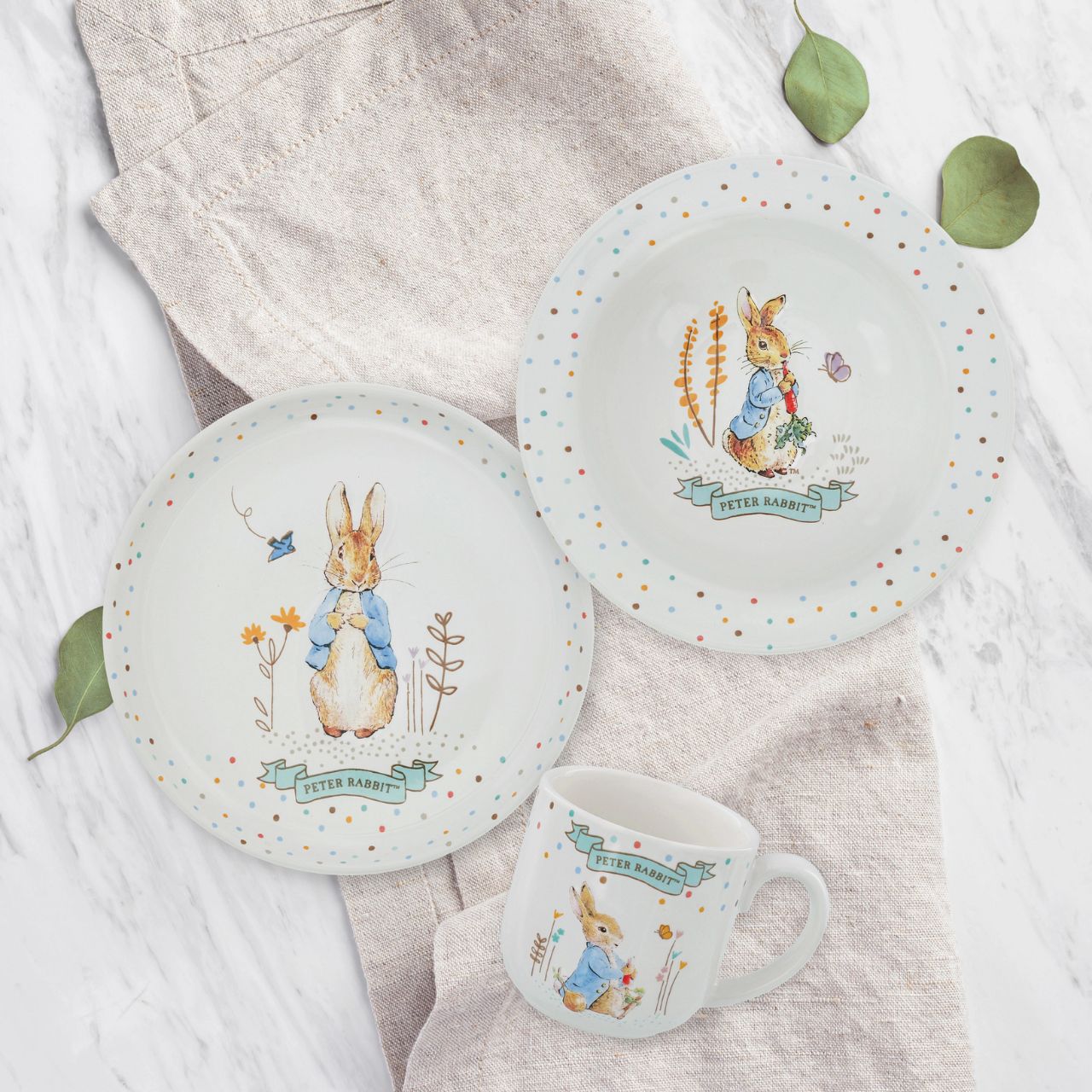 Enhance your product line-up with the delightful Peter Rabbit Ceramic Dinner Set. This beautifully crafted set includes a ceramic plate, bowl and mug all featuring embossed character artwork, showcasing the timeless charm of Beatrix Potter's beloved characters. Each piece is designed with intricate detail and vibrant colours, perfect for both daily use and display.