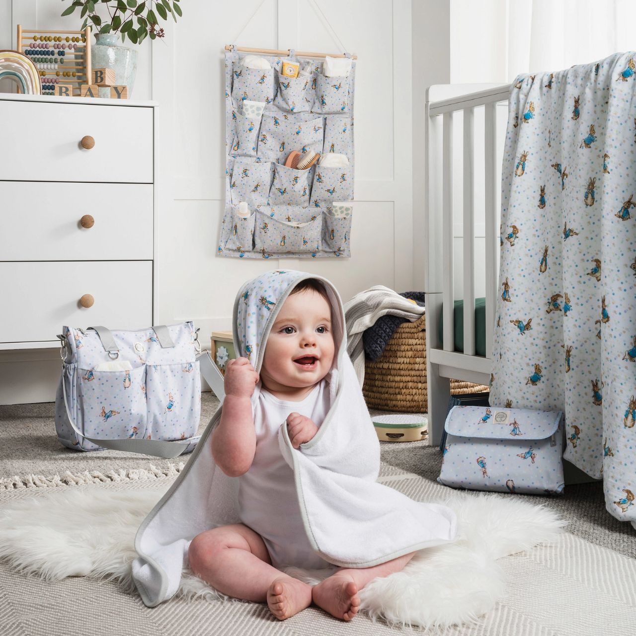 Sure to be the most-wanted piece of the whole collection is the Peter Rabbit Changing Bag. Featuring Peter Rabbit on an easily wipe-down PU fabric, off-set against pastel splashes of colour on a cool grey background