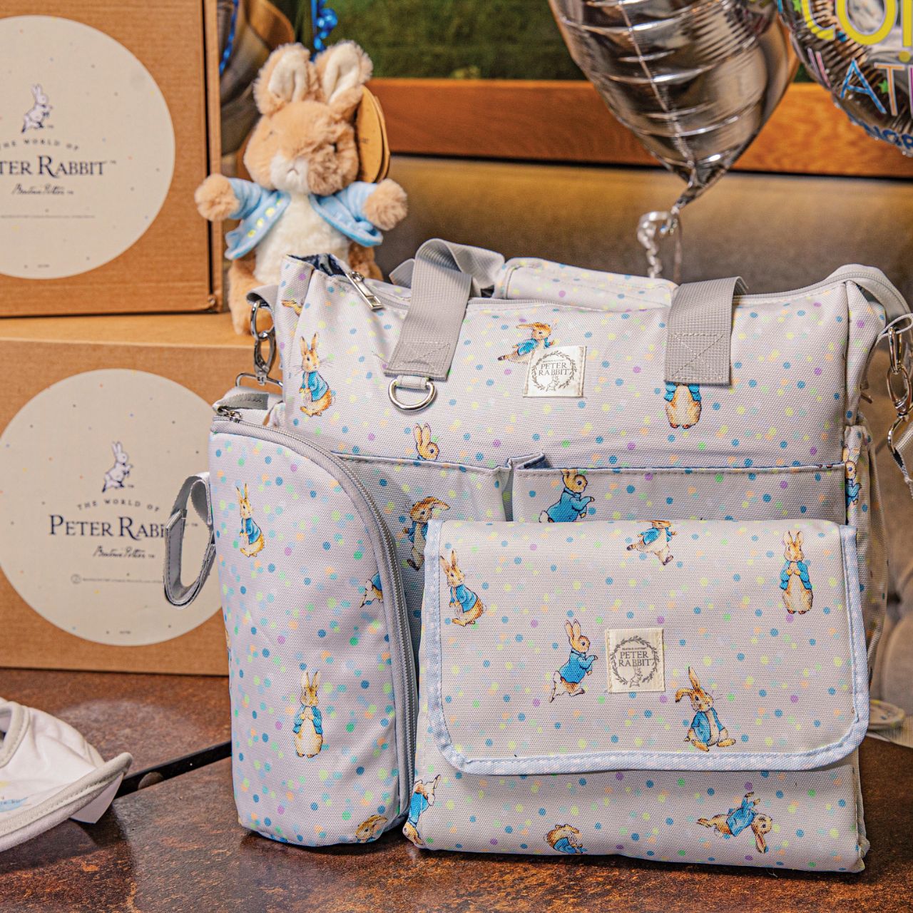 Sure to be the most-wanted piece of the whole collection is the Peter Rabbit Changing Bag. Featuring Peter Rabbit on an easily wipe-down PU fabric, off-set against pastel splashes of colour on a cool grey background