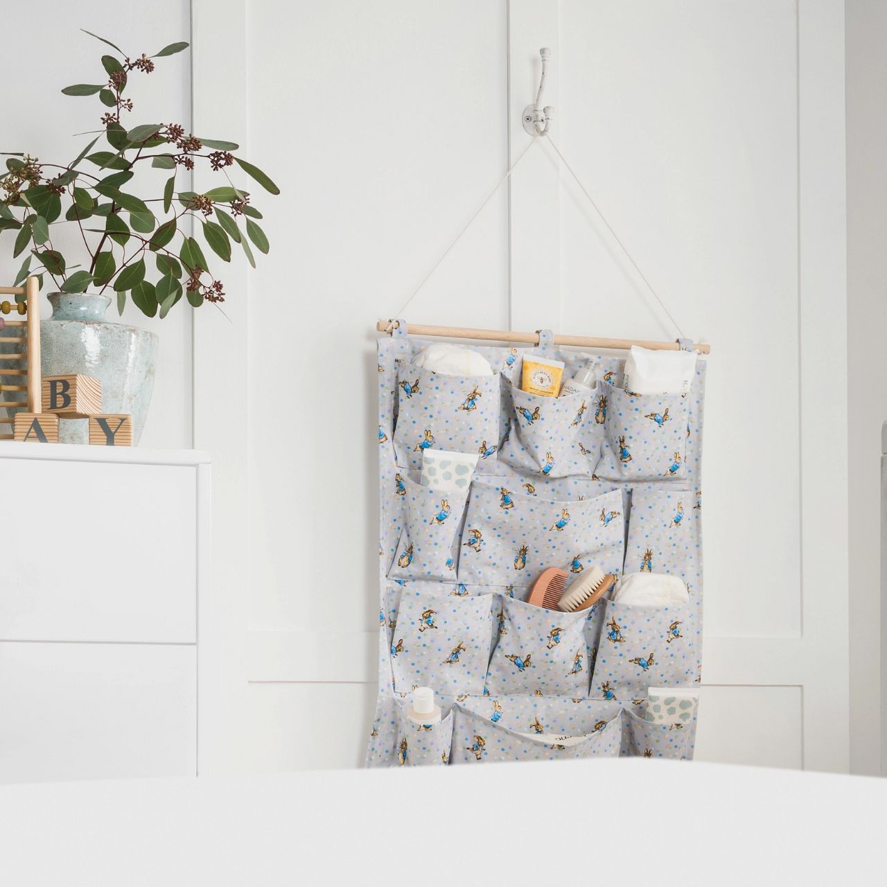 A new format to our Beatrix Potter collection, the Peter Rabbit Nursery Organiser. Featuring 12 individual pockets over 4 shelves, rope to hang the organiser on the wall and a new Peter Rabbit design, this is the ultimate organiser for your nursery.