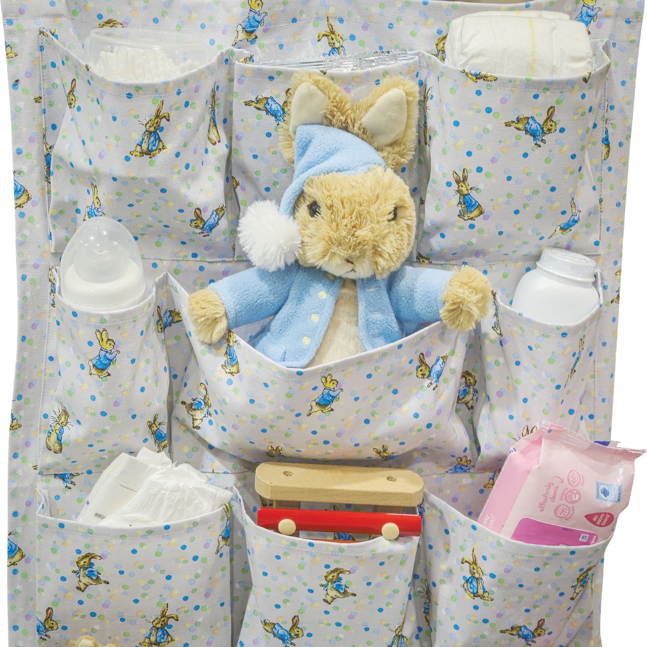 A new format to our Beatrix Potter collection, the Peter Rabbit Nursery Organiser. Featuring 12 individual pockets over 4 shelves, rope to hang the organiser on the wall and a new Peter Rabbit design, this is the ultimate organiser for your nursery.