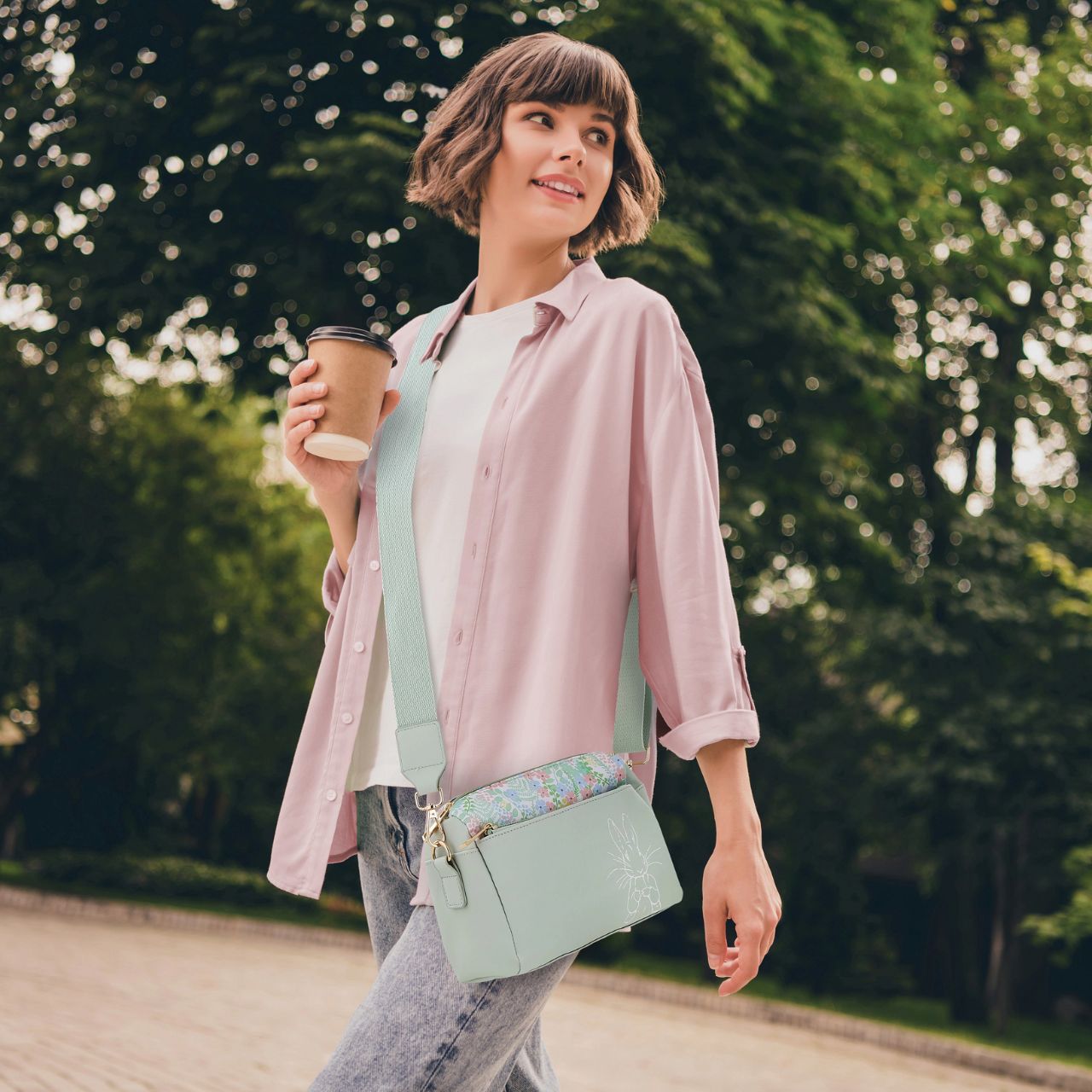 Discover elegance with our faux leather Beatrix Potter Crossbody bag. Featuring adjustable and removable straps, Gold colour metalwork plus internal pockets for easy organization. Comes with a branded dust bag-perfect for those who love timeless charm and functionality.