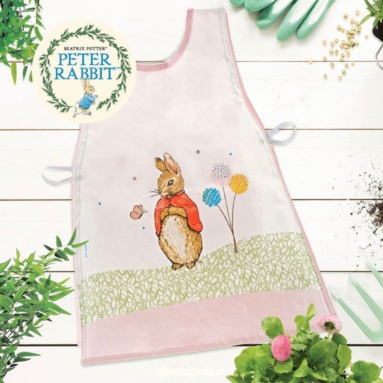 Beatrix Potter Flopsy Children's Tabard  This beautiful Flopsy double sided tabard is perfect for little ones who love baking, painting or generally getting into mischief and making a mess. They have a gloss laminated coating so are easy to wipe down. The front features a large scale Flopsy, taken directly from the original illustrations, from the Beatrix Potter stories.