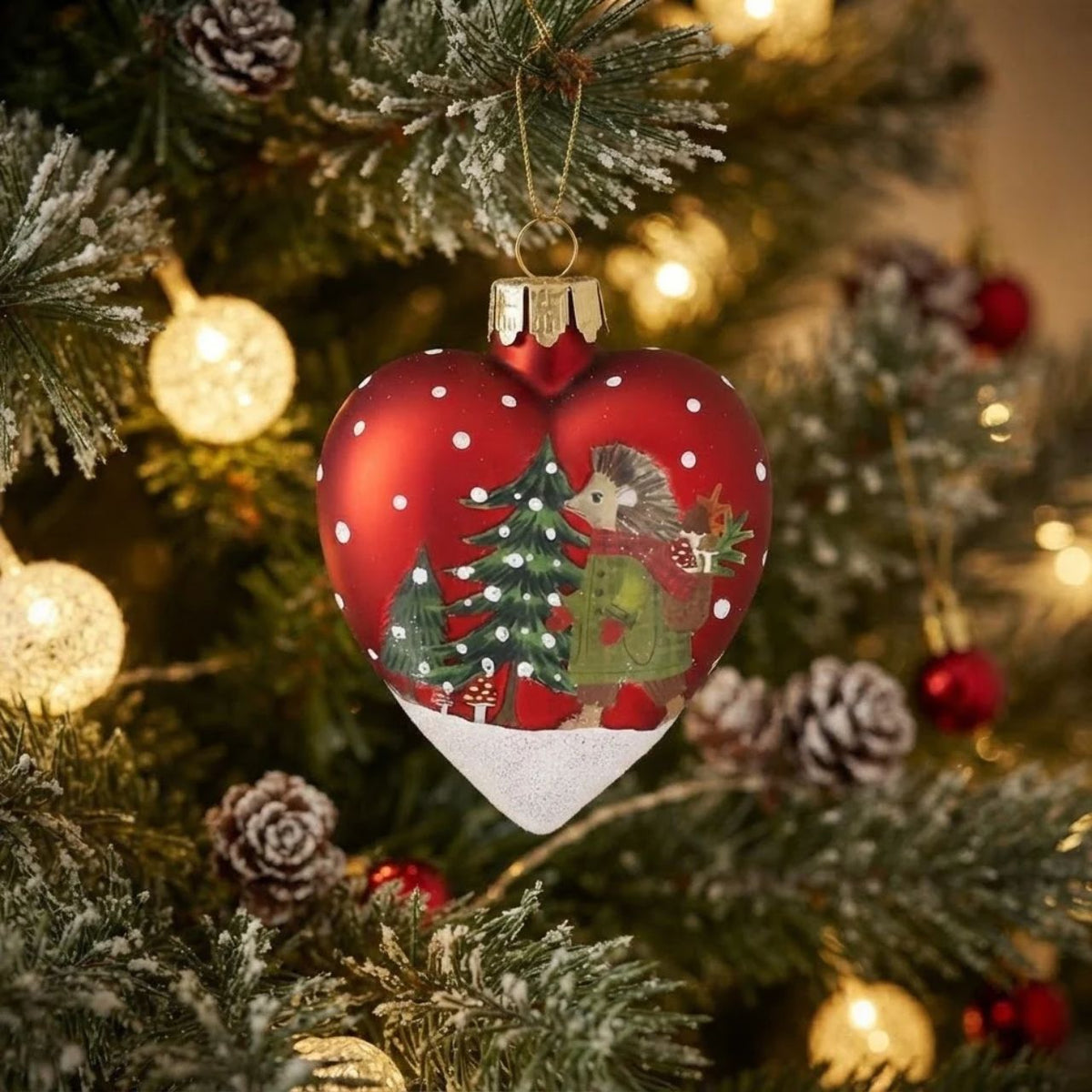 Charming heart-shaped glass ornament from Gisela Graham's festive collection. Features a cheerful plaid animal design perfect for adding personality to your Christmas tree. Handcrafted glass construction ensures durability and a beautiful sparkle when light catches it.