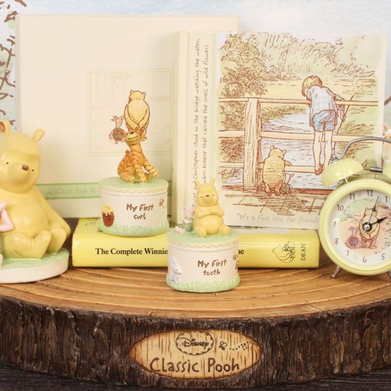 The album also reads: 'Pooh, Piglet and Christopher stood on the bridge watching the water, feeling the warm breeze that carried the smell of wild flowers.'