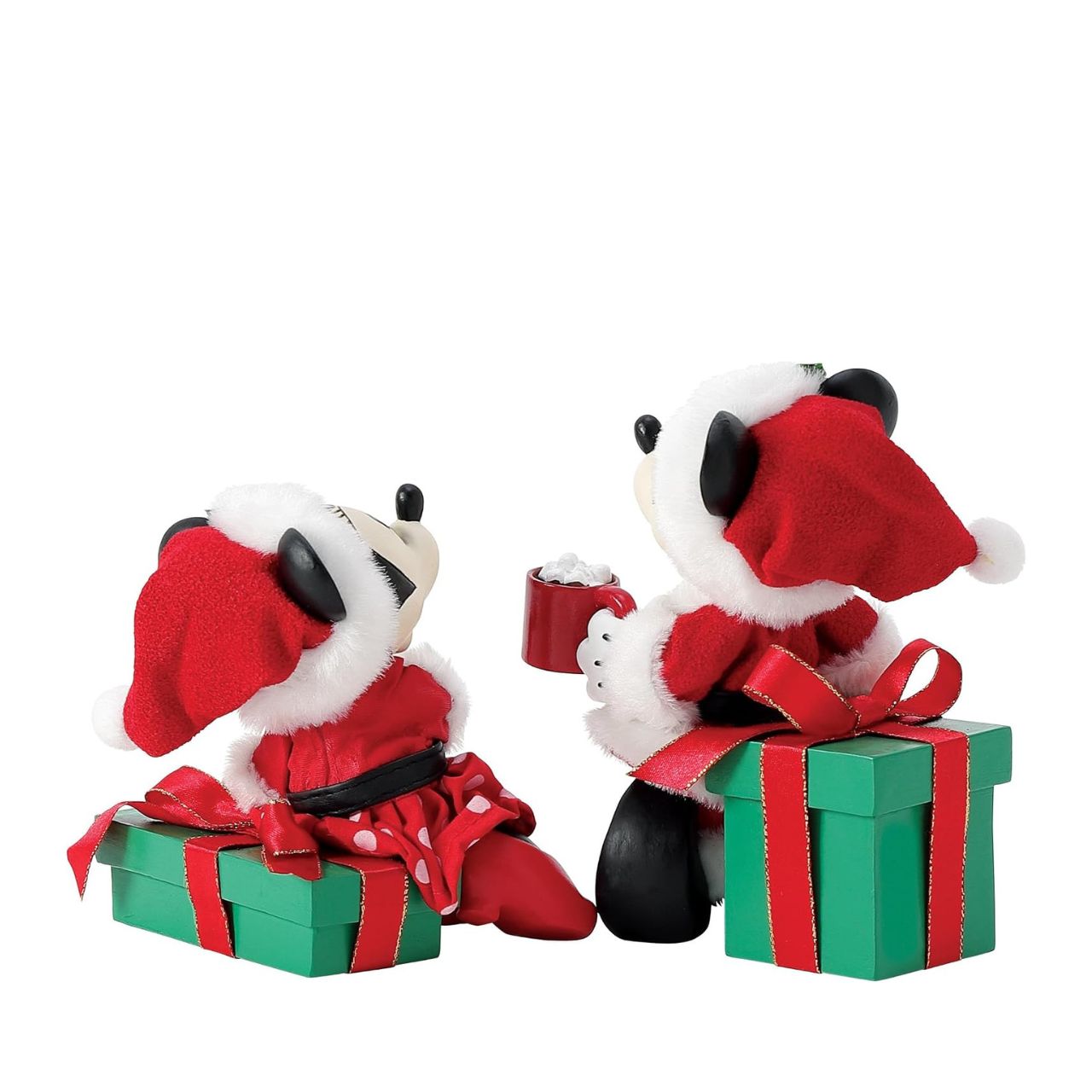 Capture the magic of the season with this charming Department 56 Disney figurine. Mickey and Minnie Mouse are nestled together on festive wrapped gifts, each cradling a steaming mug of hot cocoa—the perfect scene of cosy holiday togetherness.