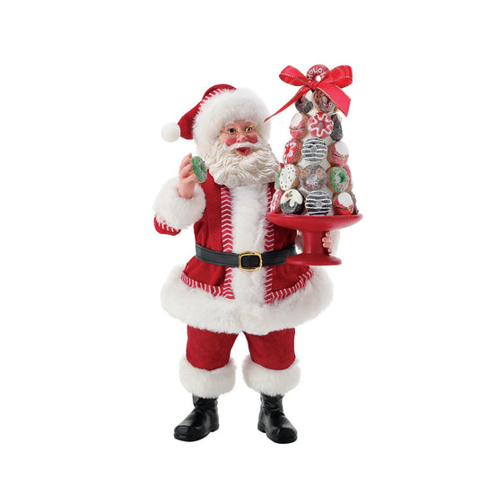 Donut Tower from Possible Dreams captures Santa in with a pile of sweet treats. Carefully balancing his plate, this piece has been made with high quality cast stone and dressed in Clothtique - a stiffened fabric - to ensure that it keeps its shape for all the years you display it during the festive period.