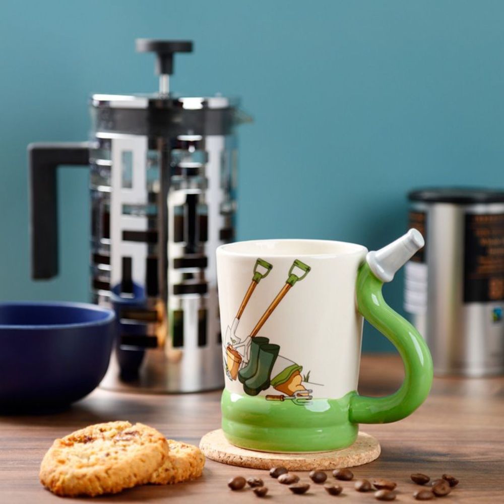 Garden Hose Ceramic Shaped Handle Mug  This ceramic mug has a uniquely designed handle shaped like a garden hose, perfect for your favorite hot beverage. The ceramic construction provides insulation, keeping your drink warm for longer. Enjoy your tea, coffee, or cocoa with the Garden Hose Ceramic Shaped Handle Mug.  An ideal fun gift for family and friends who love a tea or coffee while gardening.