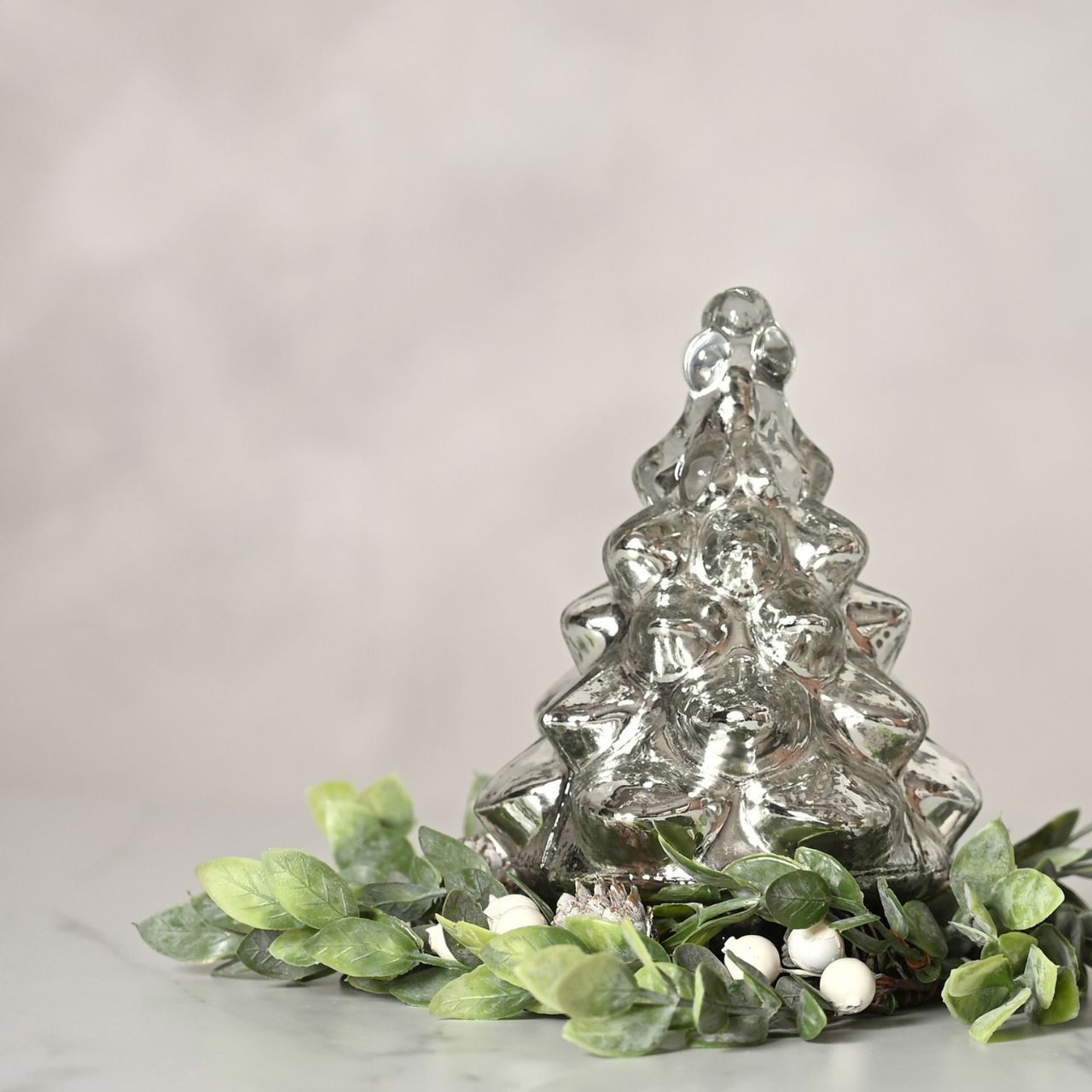 Recycled Glass Silver Christmas Tree Ornament  A recycled glass silver Christmas tree ornament from THE SEASONAL GIFT CO.  This affectionately designed ornament makes a delightful addition to homes during the festive period.