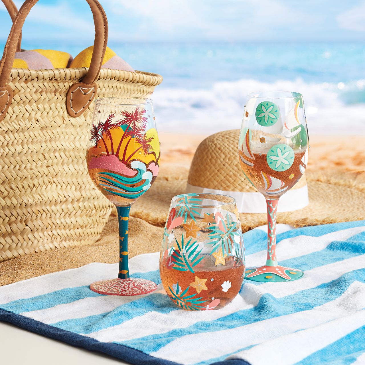 The Sailboats &amp; Sand Dollars Wine Glass by Lolita is a stunning Summer accessory, whether you're sailing or sunbathing| Bright blues combine with punchy coral pink to make a joyous ode to days at the beach.