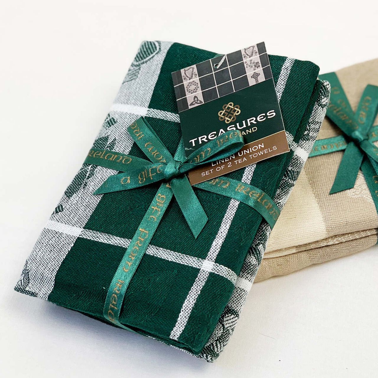 Treasures of Ireland Tea Towel Green by Samuel Lamont  Treasure of Ireland linen union tea towel in beautiful Irish green. This striking colourway comes as a bale of two, tied with elegant green ribbon. Perfect for gifting as a keepsake souvenir with it's iconic Irish symbols.