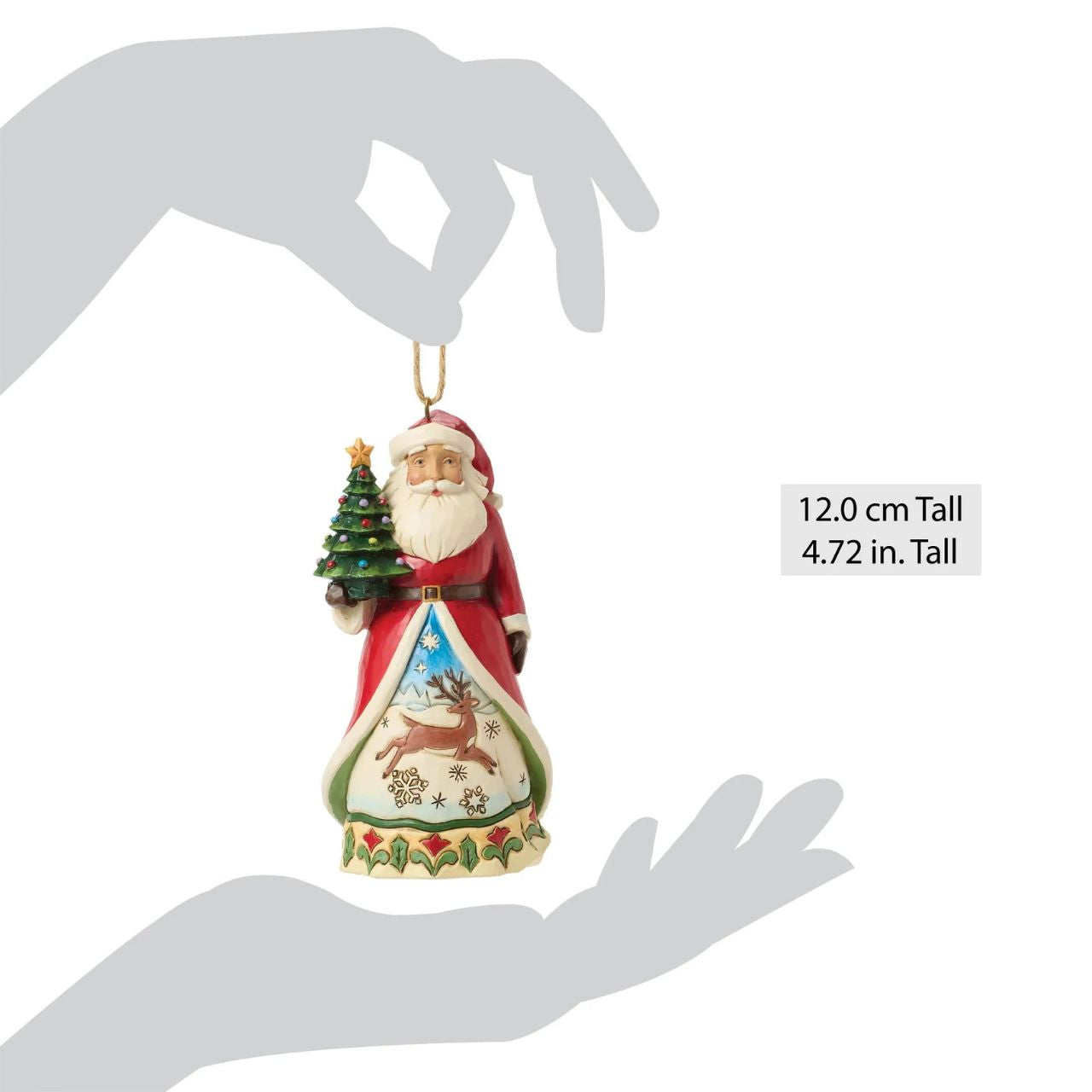 This enchanting Jim Shore Christmas tree ornament features Santa holding a miniature tree and gifts, ready to spread holiday cheer. His cloak opens to reveal a serene winter scene with a playful reindeer frolicking through the snow.