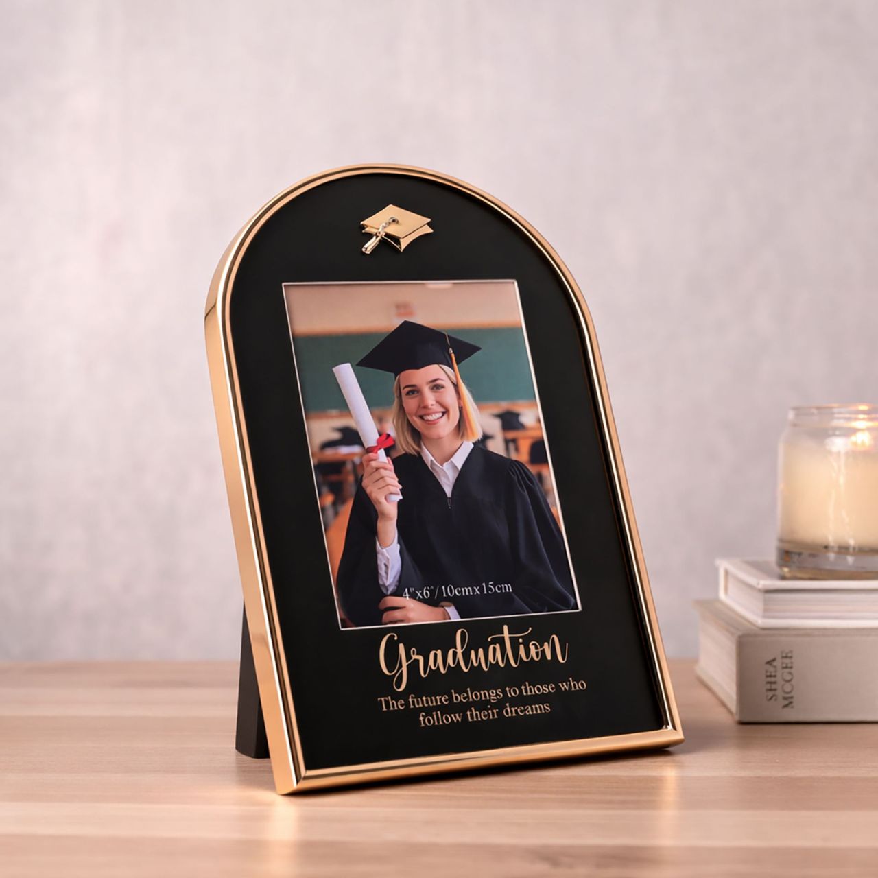 The School Years Arch Frame 4" x 6" - Graduation is a stylish keepsake designed to celebrate a proud achievement. Featuring an elegant arched shape with a black backdrop and gold-tone detailing, it is finished with a graduation cap icon and an inspiring message for a meaningful presentation.
